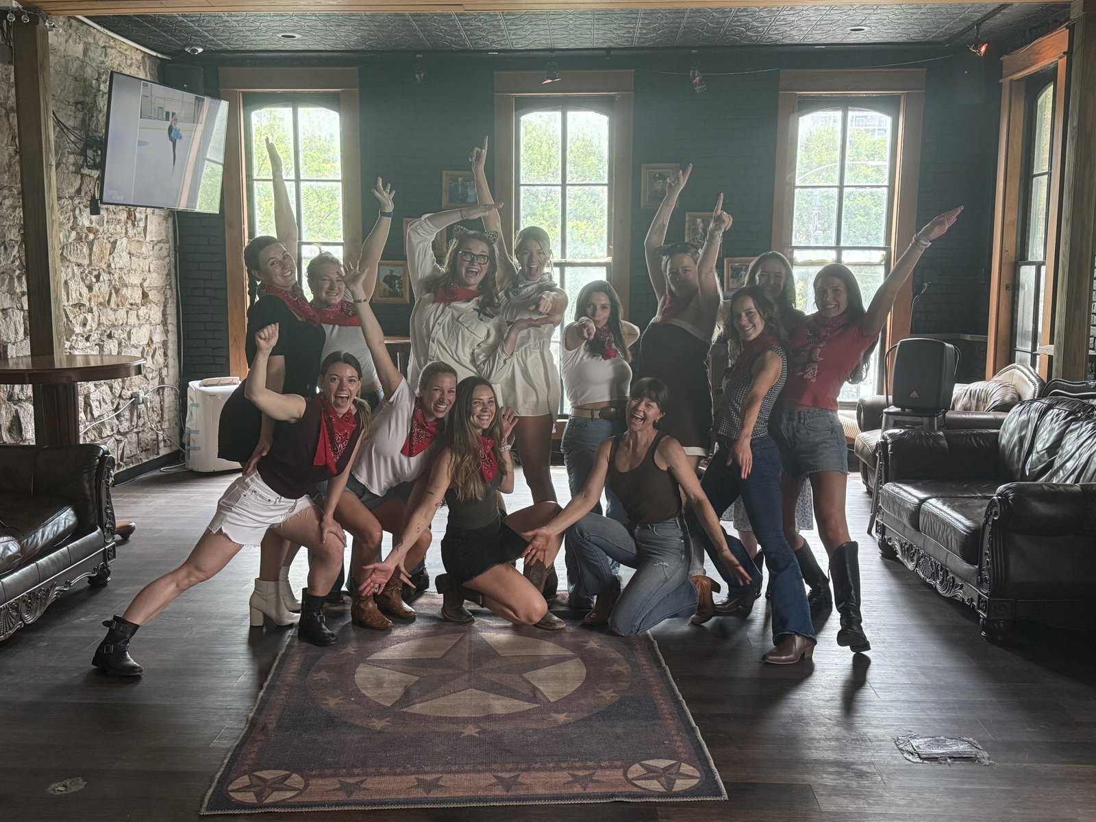 Austin group dance party with red bandanas on Texas star rug